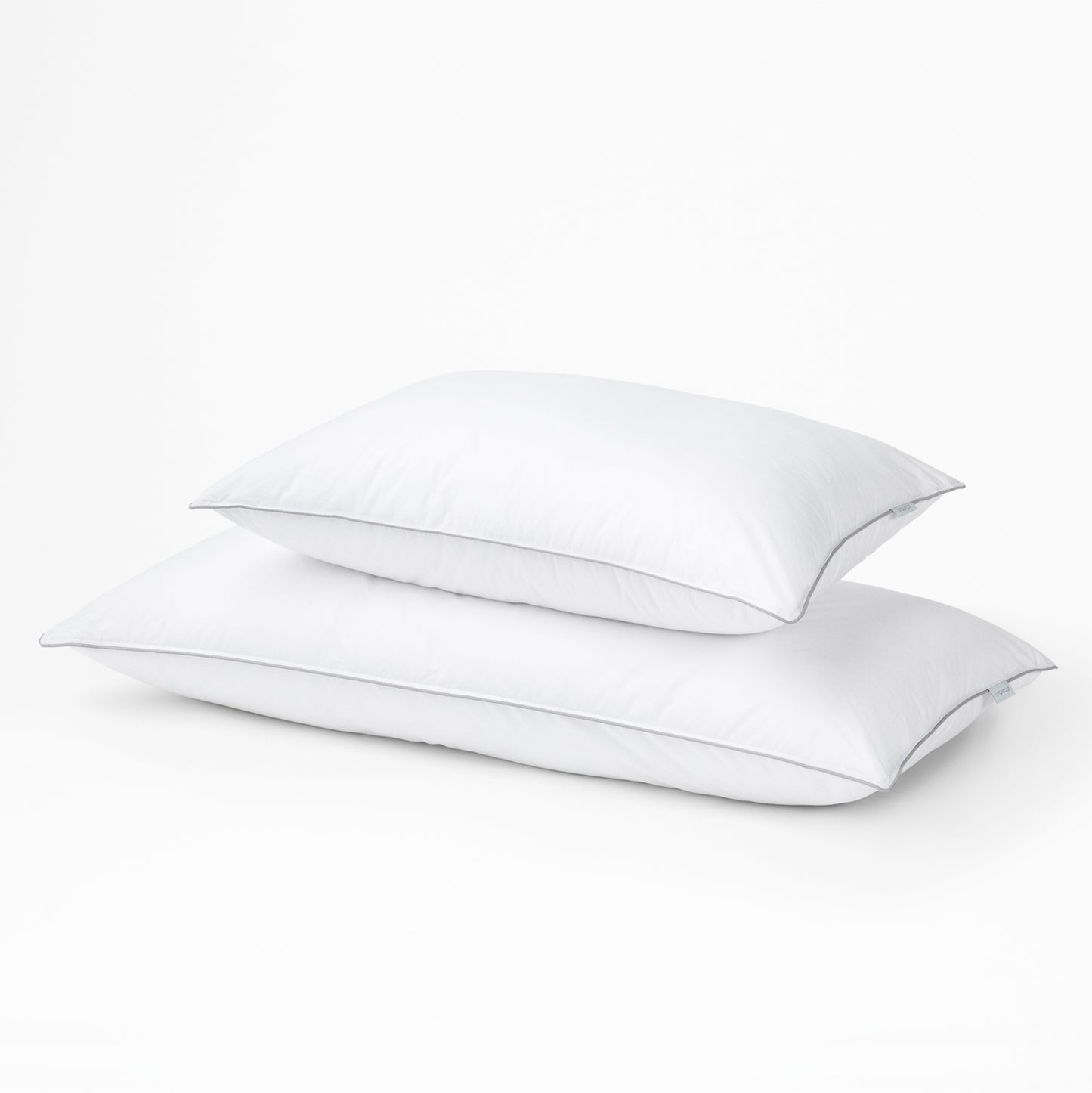 Two Tuft & Needle white pillows on a light gray background