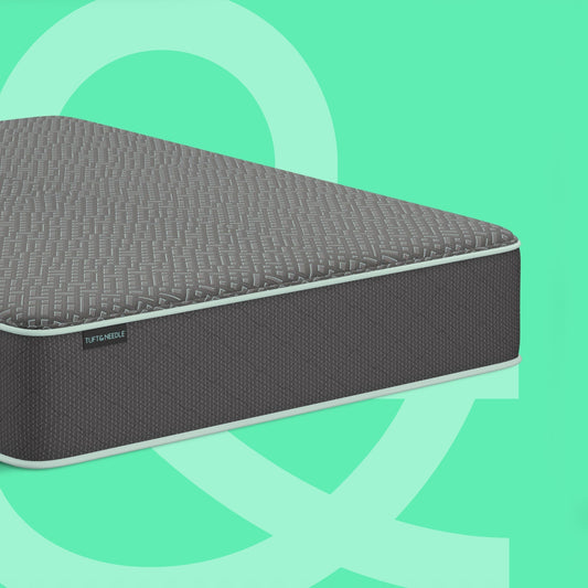 Corner of a Tuft & Needle mattress on top of a mint background