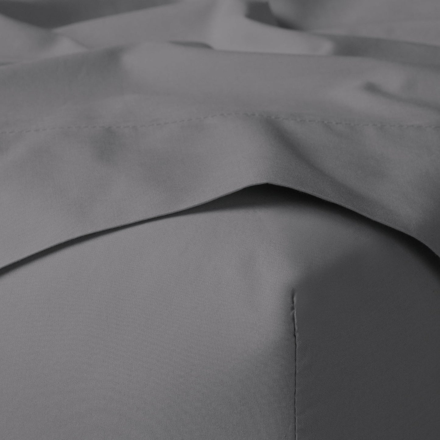 The Tuft and Needle Classic Percale Sheet Set, corner of a mattress with both sheets showing || color: Gray Quill
