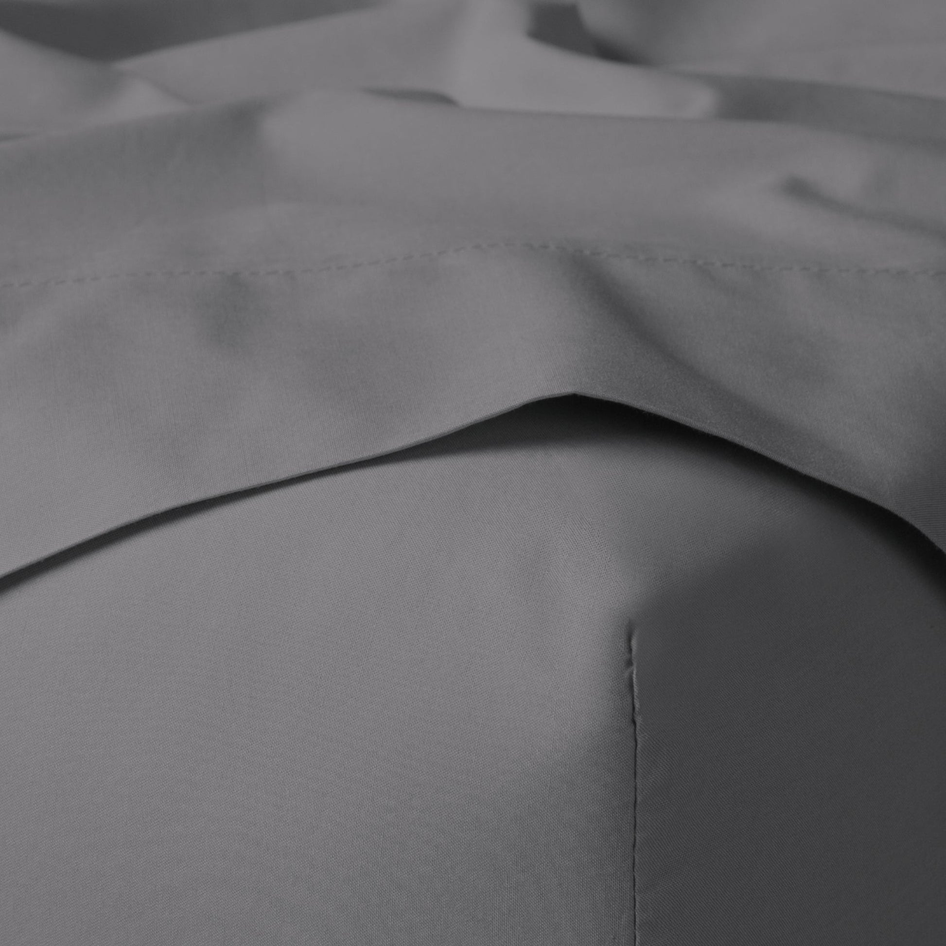 The Tuft and Needle Classic Percale Sheet Set, corner of a mattress with both sheets showing || color: Gray Quill
