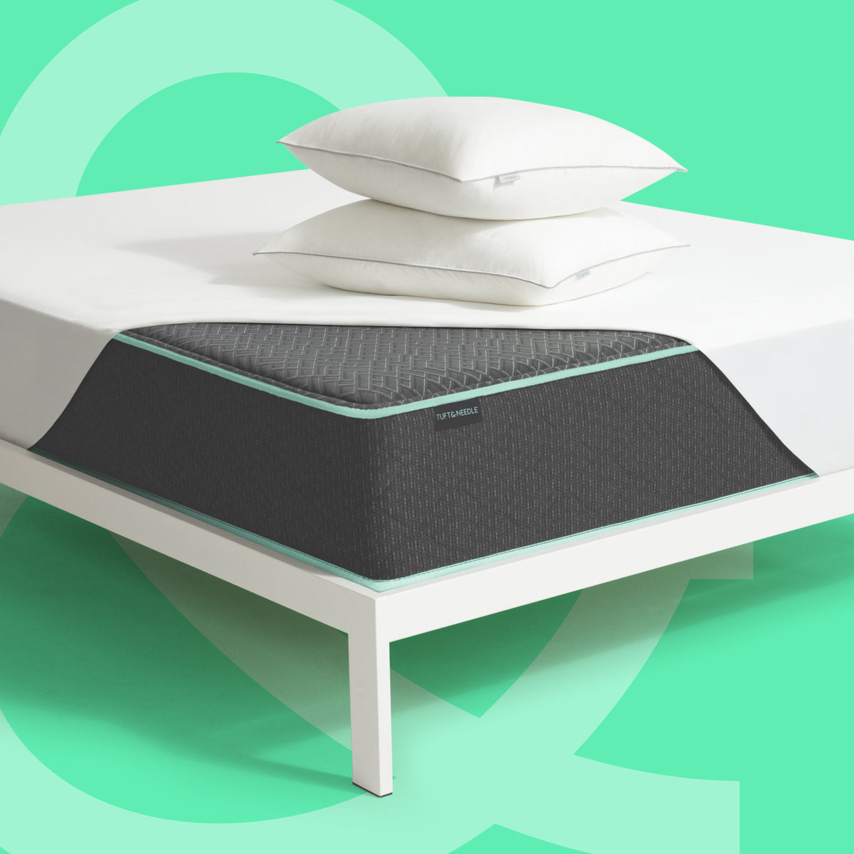 Tuft & Needle Original Mattress II with mattress protector and two pillows on a white bed frame