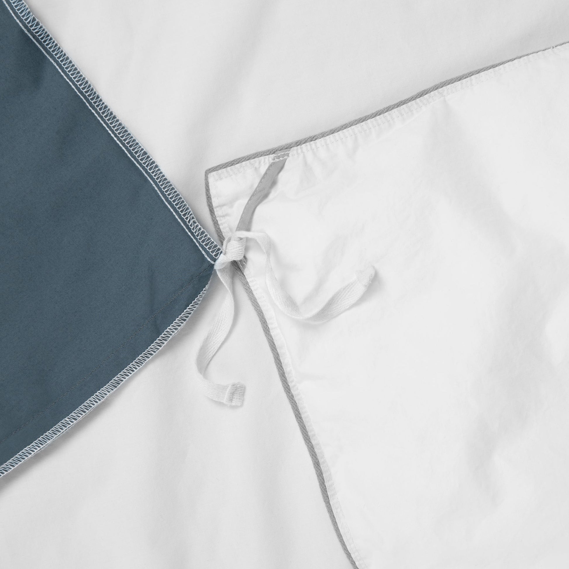 Close-up view of the corner ties on the Tuft and Needle Percale Duvet Cover Set||color:sand