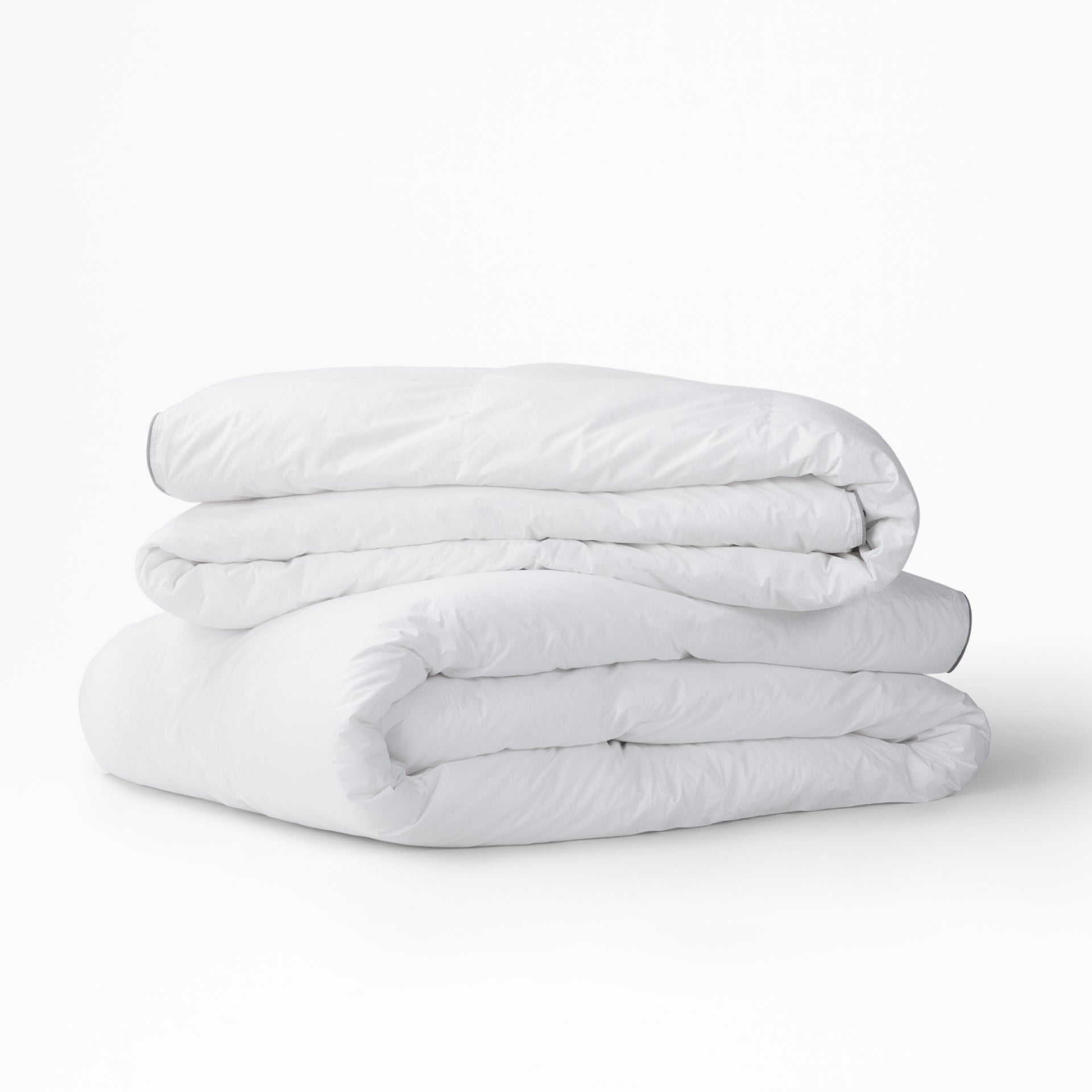 Two Tuft and Needle Alternative Duvet Inserts folded on a white background||weight:medium